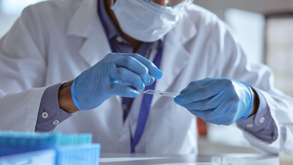 A Black doctor prepares a test slide
