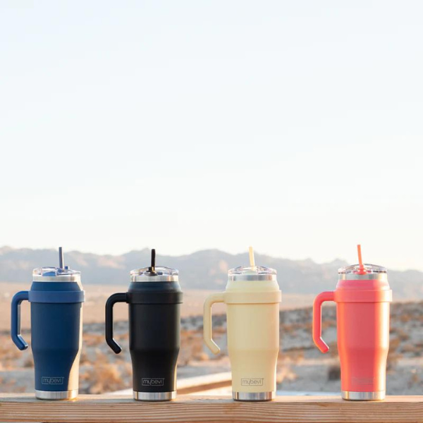 Four colorful MyBevi Outlander resusable cups against mountain backdrop