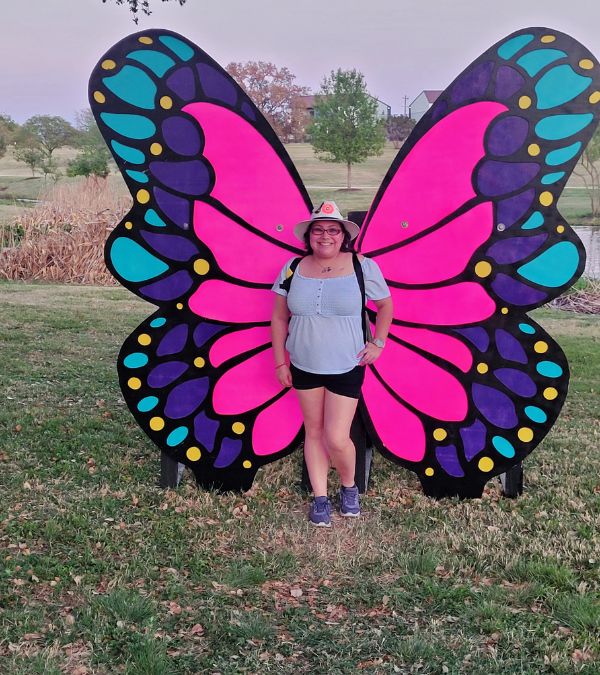 Ashlynn Gomez wears brightly colored butterfly wings