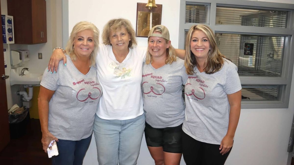 Carolyn Nickels, her sister, and her nieces, stand with their arms around each other