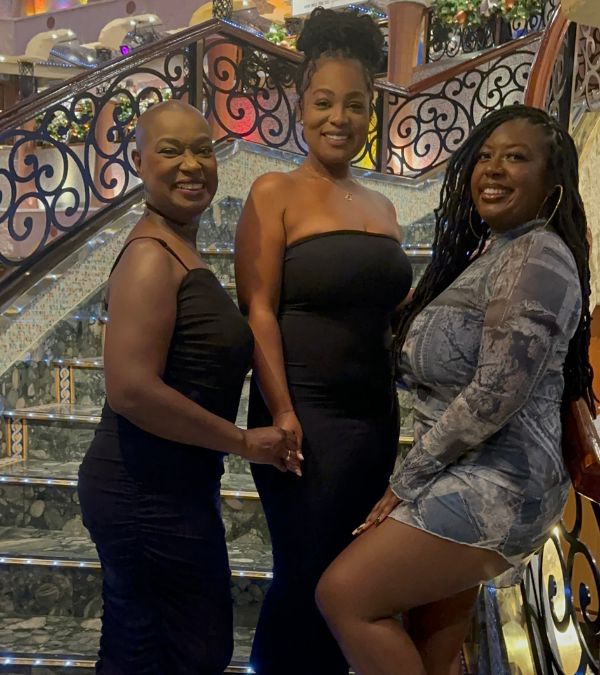 Terlisa Sheppard and her two daughters wear formal wear as they stand on ballroom steps
