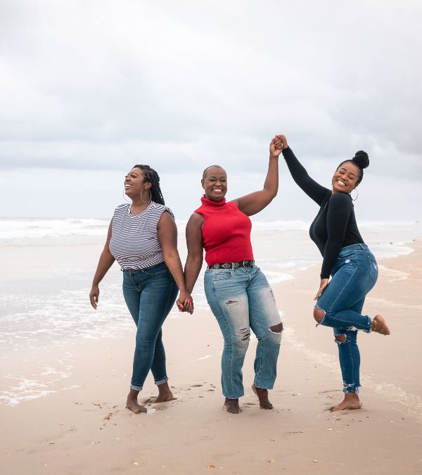 Terlisa Sheppard and her two adult daughters frolic on the beach