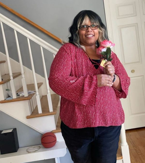 Stephanie Smith holds a flower joyfully