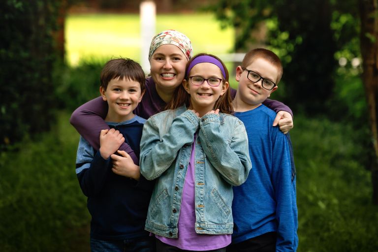 Jenni Hetzel-Gaynor hugs her nephews and niece with a big smile