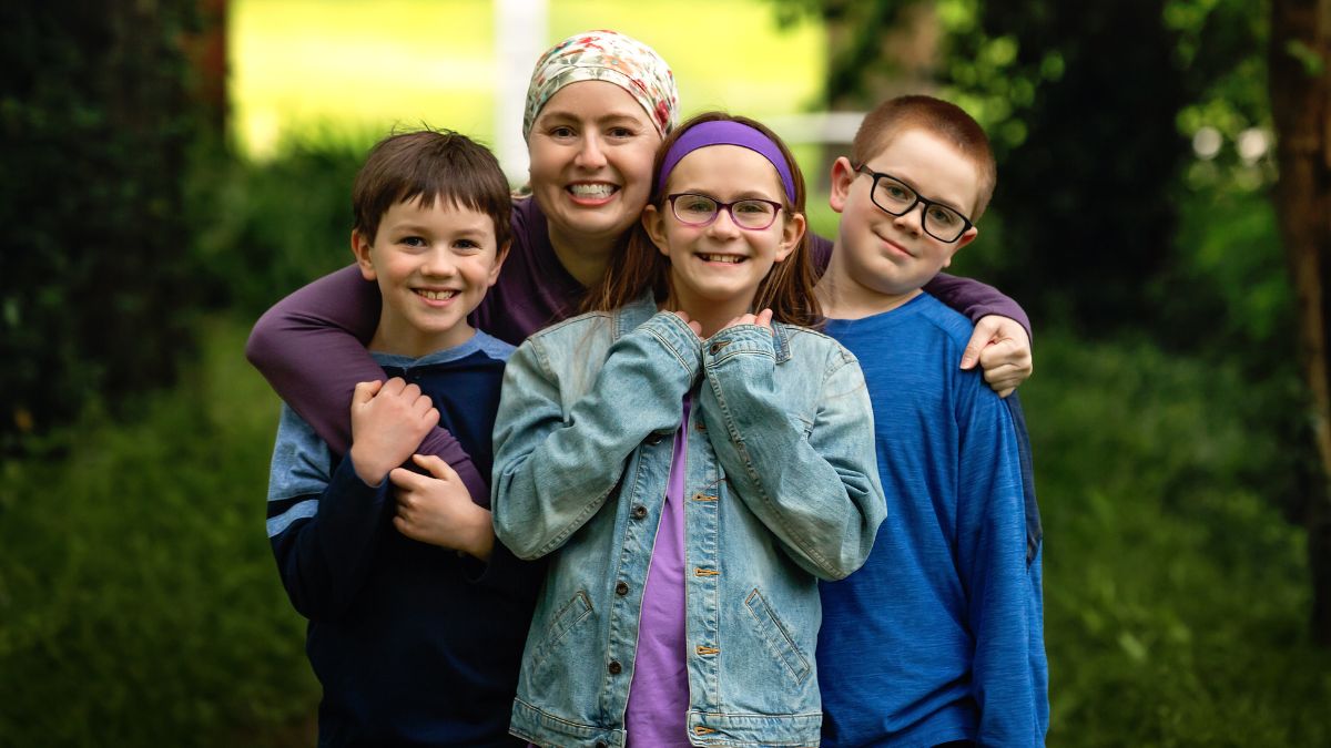 Jenni Hetzel-Gaynor hugs her nephews and niece with a big smile