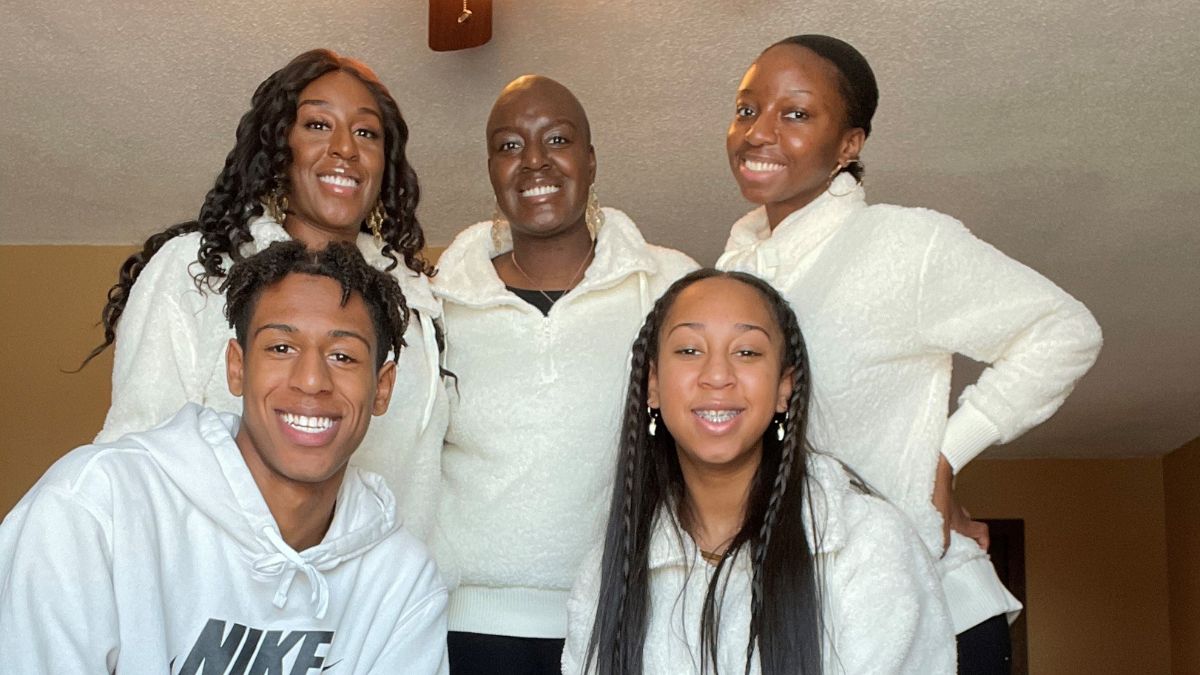 Victoria Seamon with her sisters and her niece and nephew, all posing proudly in white hoodies
