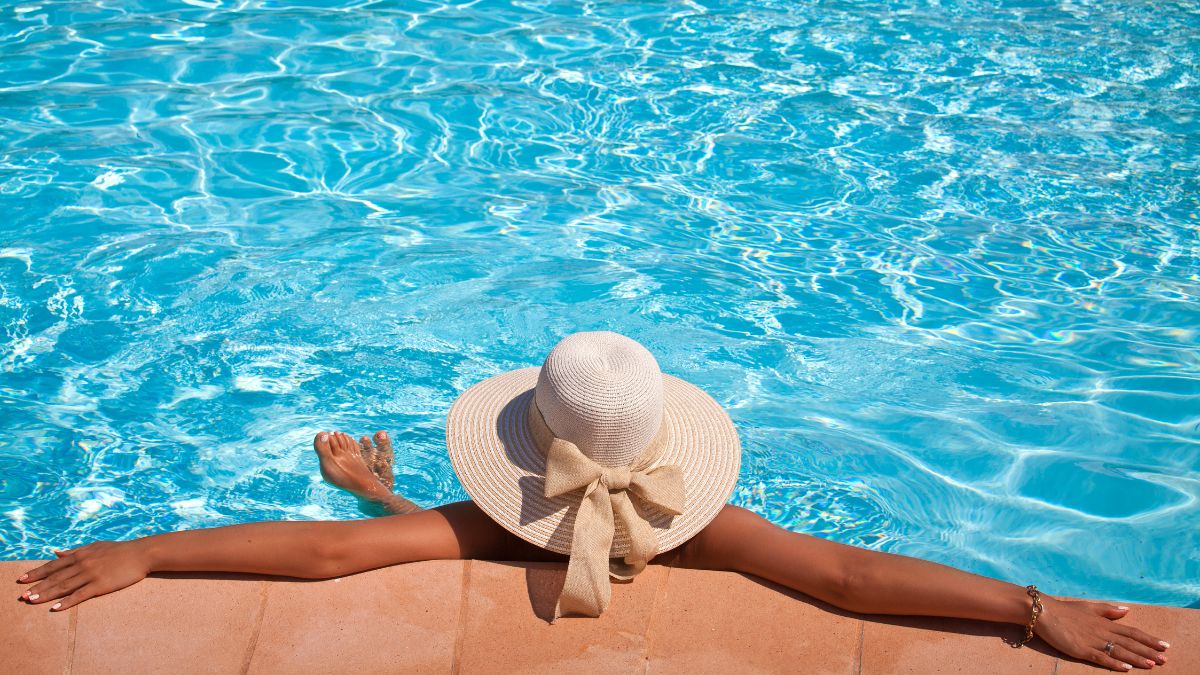 Woman laying against a pool wall