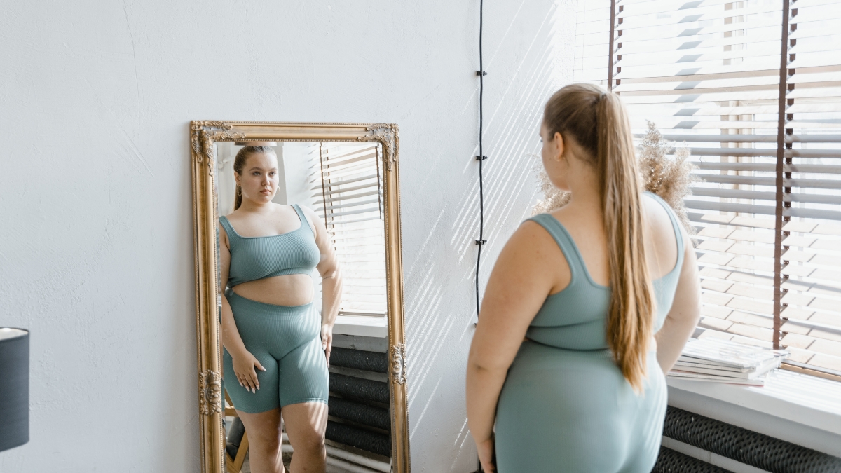 Woman looking at herself in the mirror