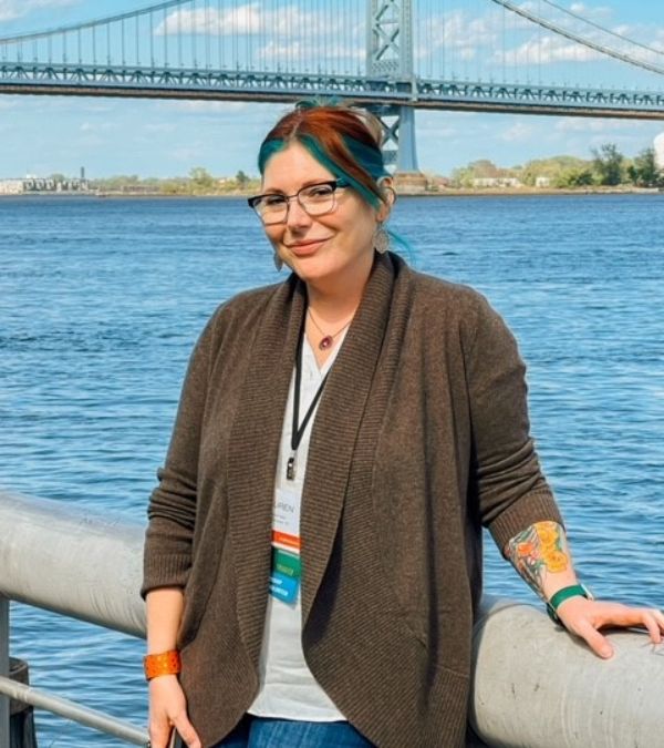 Lauren Izzo in recent times with an urban riverscape behind her