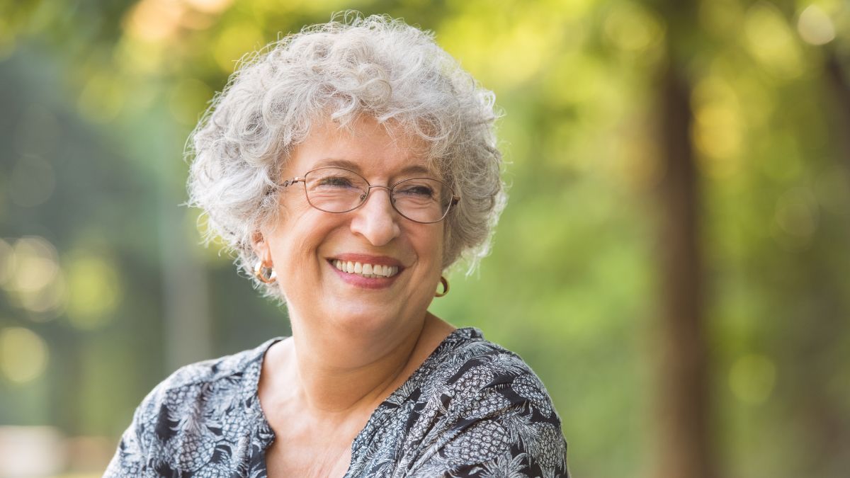 Elderly woman smiling outside