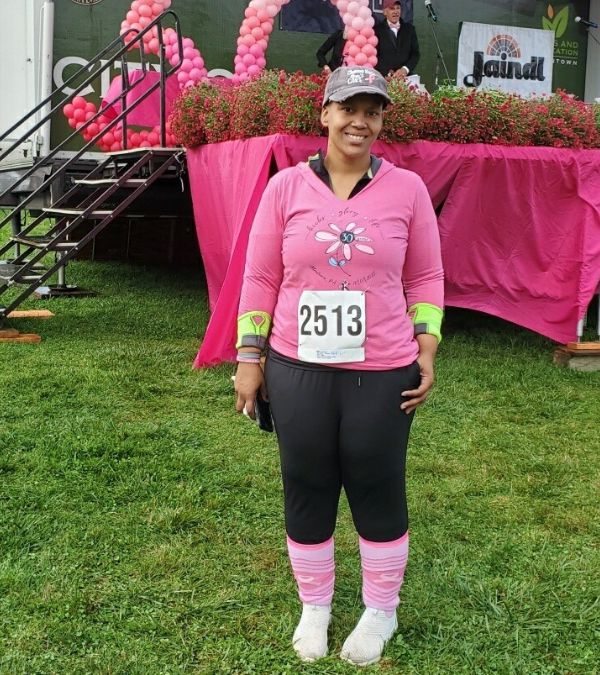 Angel Rinker wears pink athletic top at a breast cancer event
