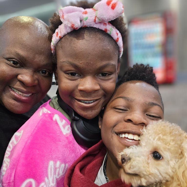 Ebony-Joy Igbinoba with her two children and puppy.