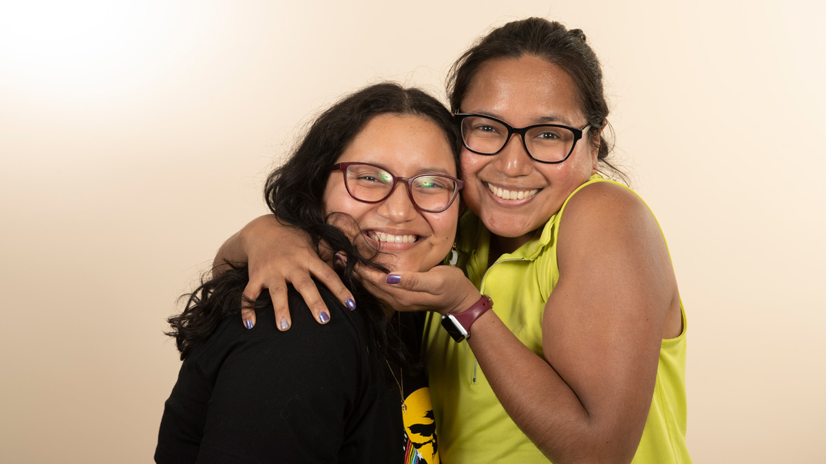 Two young women embracing