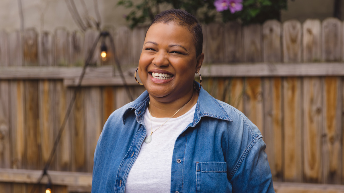 Woman standing outside, smiling