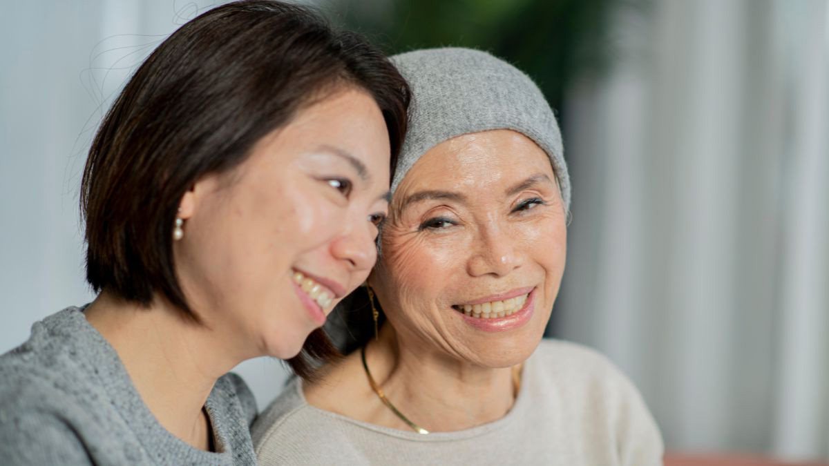 Two asian women smiling.