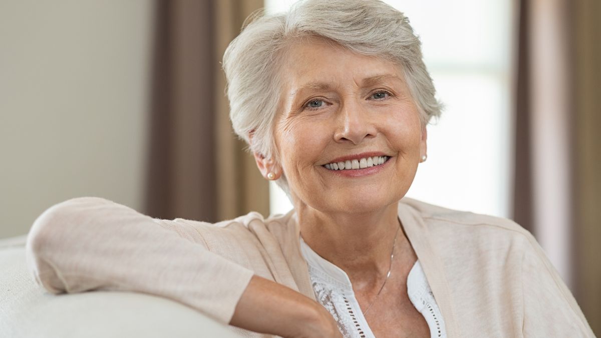 An older white woman smiling.