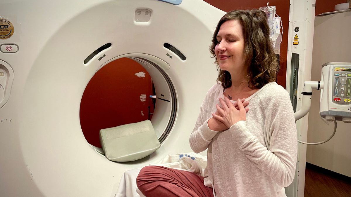 Bethany Adair breathes mindfully in a yoga pose before her CT scan.