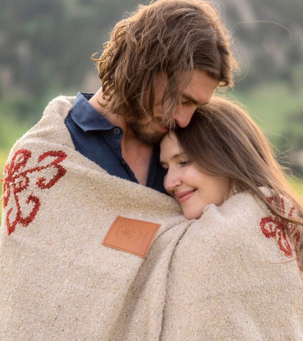 Bethany Adair and her husband wrap themselves in a blanket.
