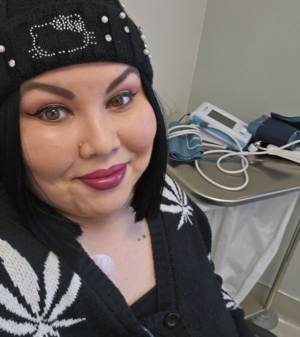 Deb Blake-Ontiveros wears a Hello Kitty beanie, looking confident and stylish as she awaits her chemo treatment.
