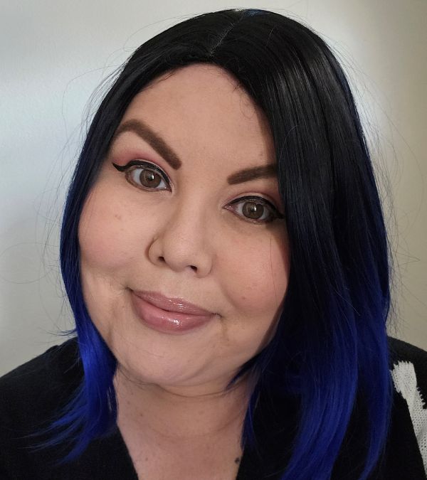 Deb Blake-Ontiveros shows off the blue tips of her hair with a confident smile.