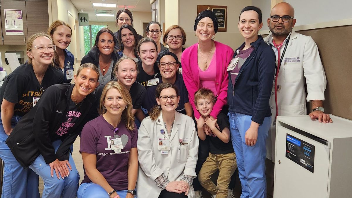 Shannon Gottesman is surrounded by nurses, doctors, other patients, at the cancer center.