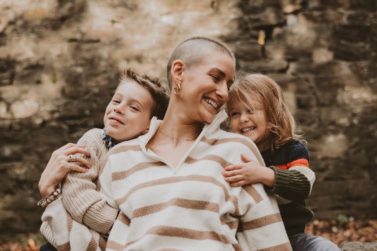 Shannon Gottesman is surrounded on either side of her by her two young boys who wrap her up with smiles and hugs.