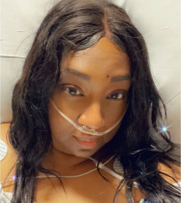 Stephani St. Cyr in a hospital bed, receiving oxygen.