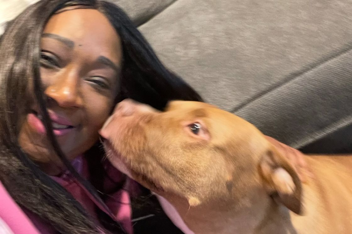 Stephani St. Cyr gets a kiss from her dog, Codee.