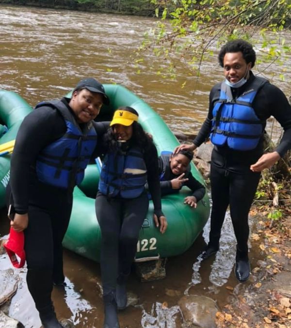 Stephani St. Cyr and her family disembark from their raft after a trip down the river.