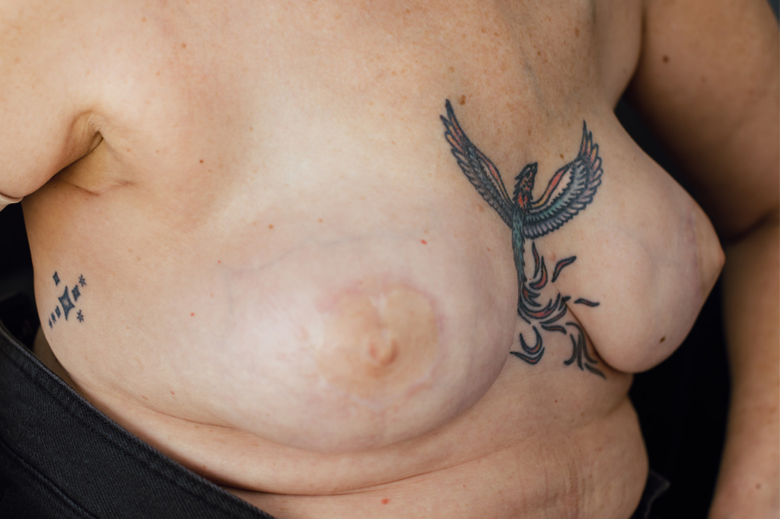 A close-up of realistic nipple tattoos on a white woman's breasts