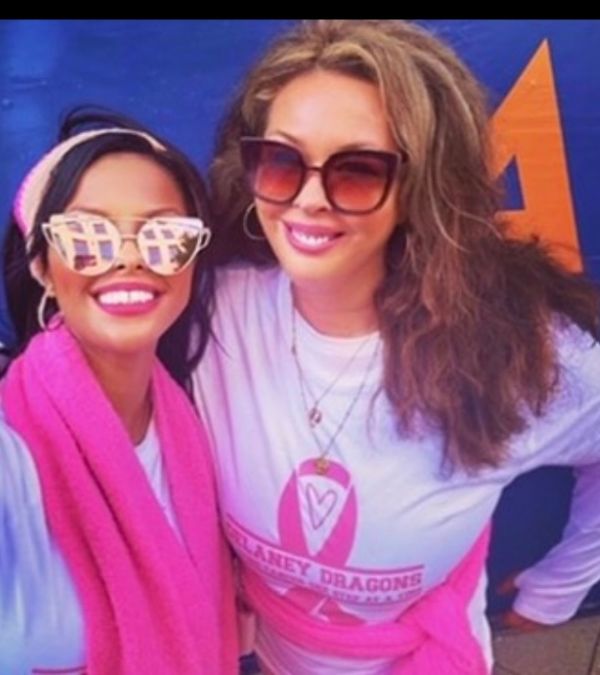 Dede Delaney and a friend pose for a picture after a breast cancer walk.