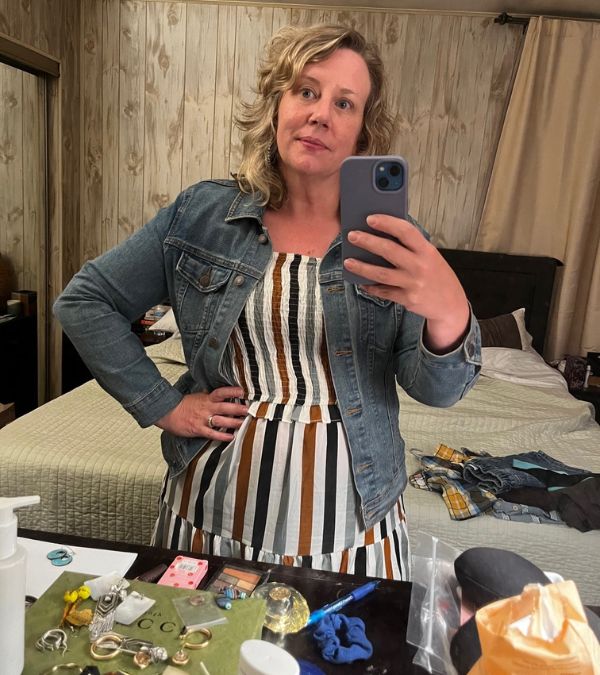 Kendra Ajuba wears a summer dress, feeling confident after breast cancer surgery.