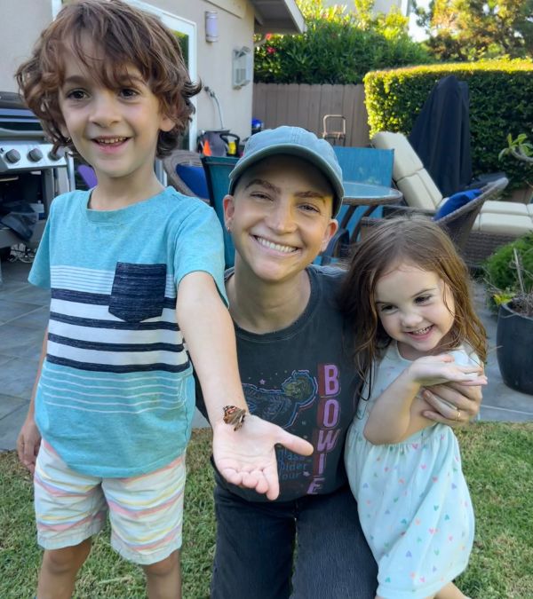Lilly Ribner hams it up with her children on a bright summer day.