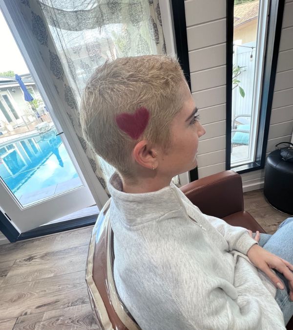 Lilly Ribner has a red heart dyed into her cropped blond hair.