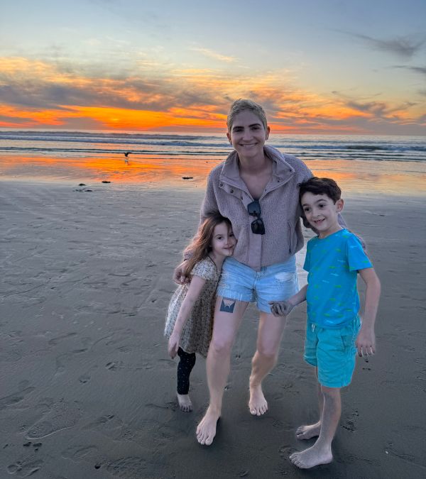 Lilly Ribner shares a happy moment with her two young children on the beach during sunset.
