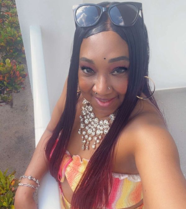 Stephani St. Cyr wears a rhinestone necklace with a sunny bathing suit on a summer day.