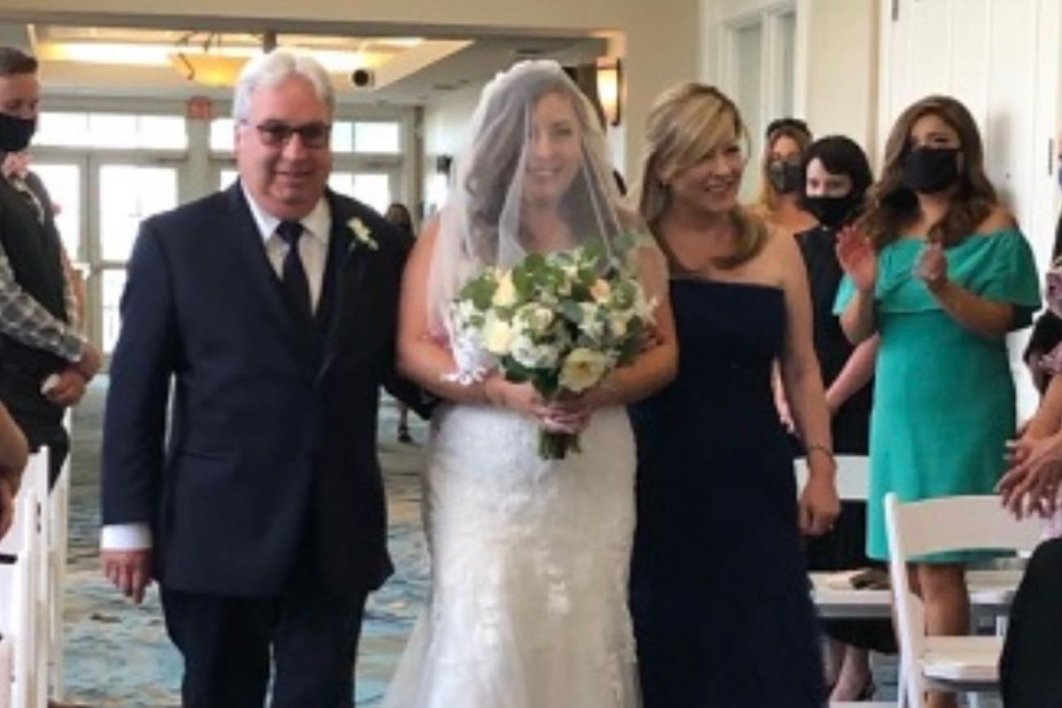Maria Lleonart and her husband walk their daughter Jade down the aisle during Jade's wedding.