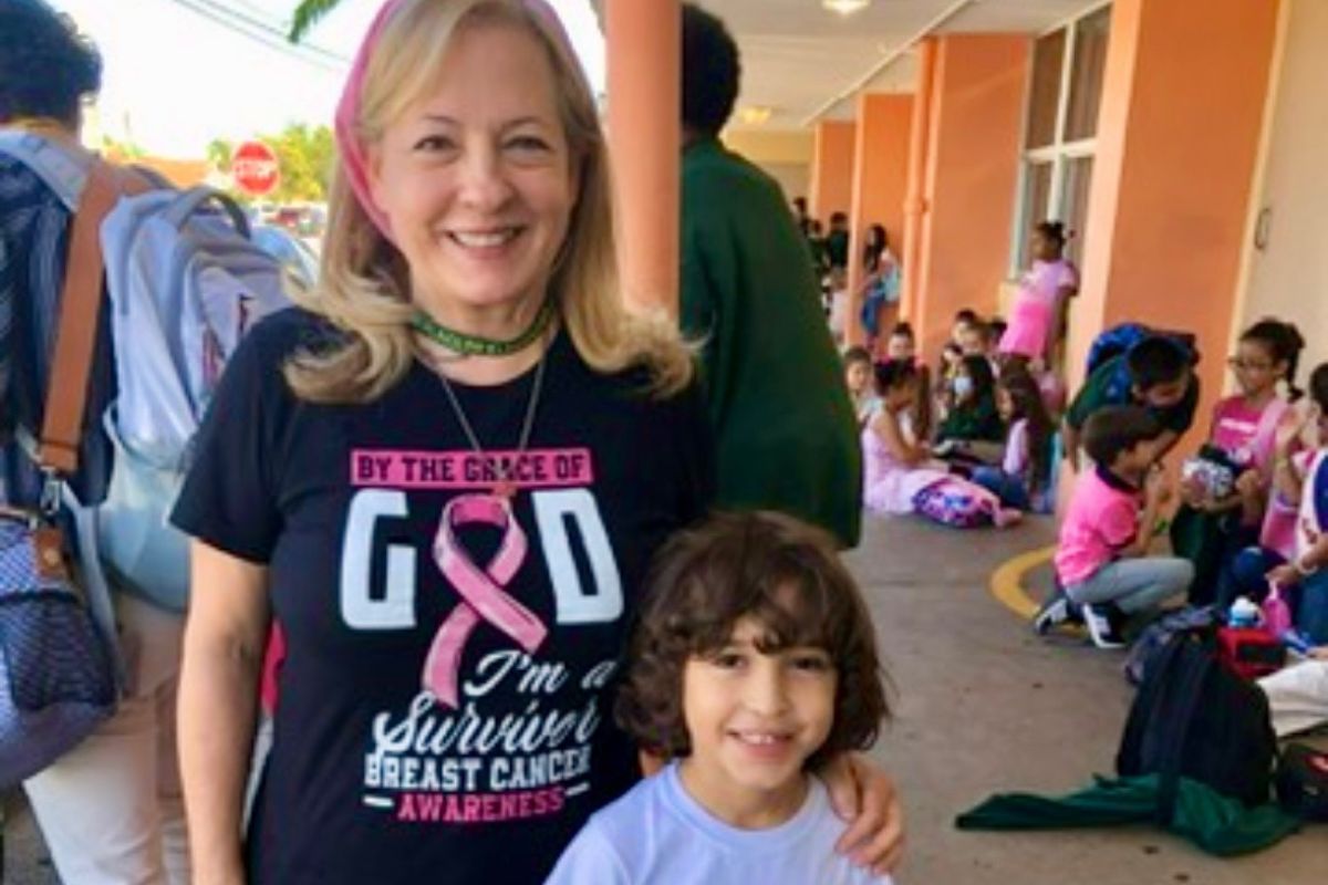 Two years after her surgery, Maria Lleonart stands with her beloved grandson, a smiling boy with tousled brown hair.