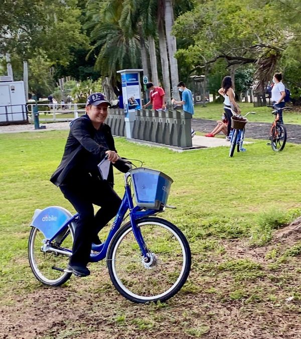 One year after she discovered her lump, Maria Lleonart rides a bicycle through a park.