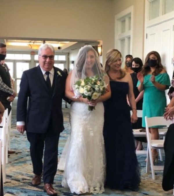 Maria Lleonart and her husband walk their daughter Jade down the aisle during Jade's wedding.