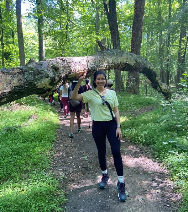 Marisa Espinosa, before chemo, stands in a beautiful and lush nature path.