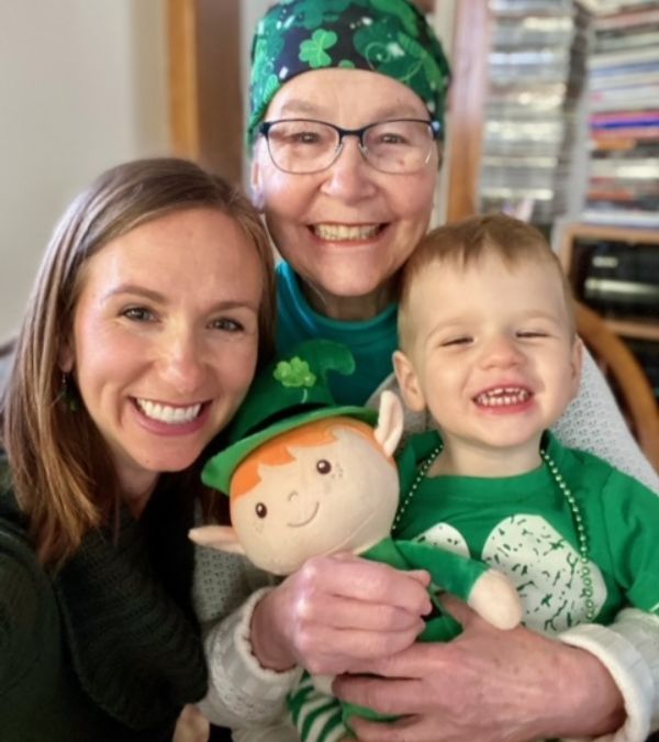 Maura Roby, her daughter, and grandson are decked out in Irish-themed garments, including Maura's headscarf.