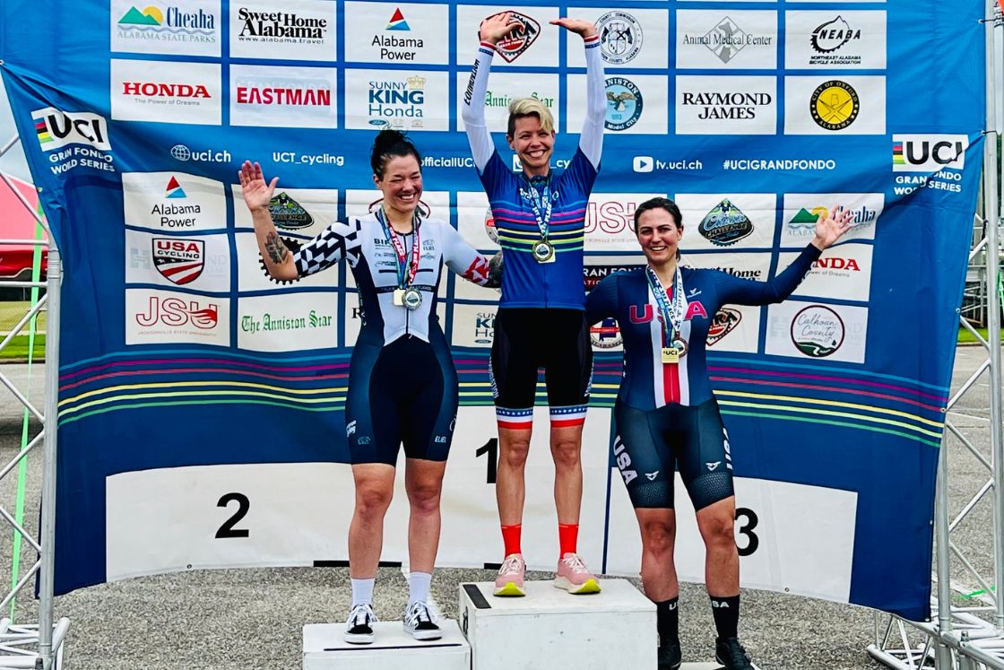 Lisa Csensits stands on a podium, having won first place in a cycling competition.