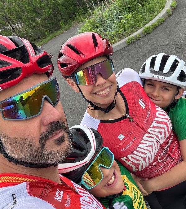 Lisa Csensits and husband and two sons demonstrate that they are a cycling family in their colorful cycling outfits, glasses, and helmets.