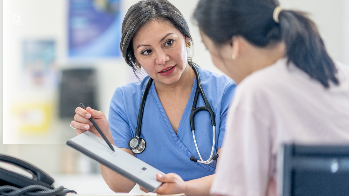 A female Asian doctor in conversation with a female Asian patient