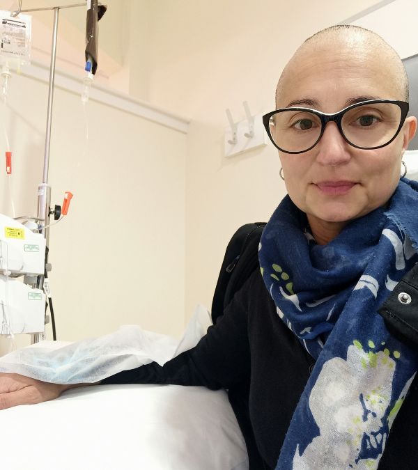 Virginia de Oliveira Marques sits for chemotherapy infusion.