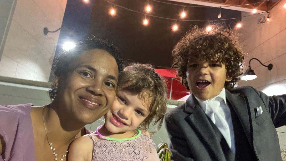 Angel Rinker attends a formal event with her two youngest children who are happy and dressed to impress.