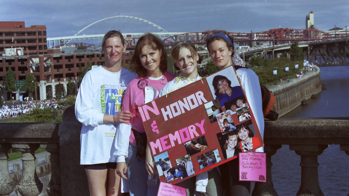 Chelsey and her three friends holding up a poster that reads, "In honor & memory"