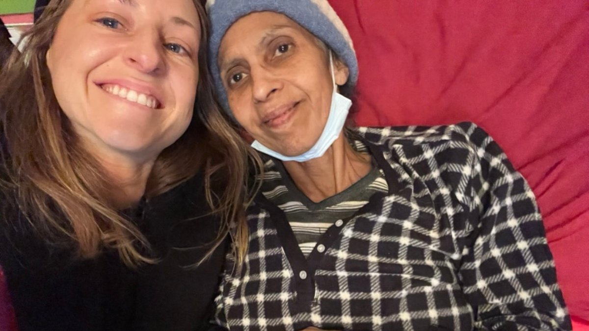 Chelsey smiling for a selfie with a friend going through treatment