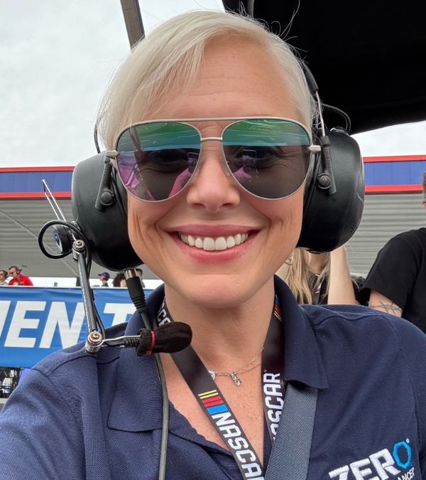 Courtney Bugler is ready to go in her Nascar vehicle, sunglasses and headset on!